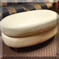 F48. Oval white leather ottoman. 